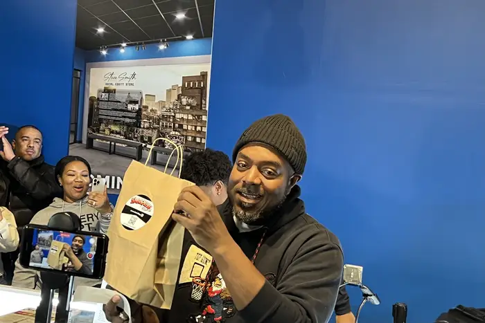 Roland Conner, the owner of Smacked, made the store’s first official purchase in front of a gaggle of press. He was rung up by his son, Darius.
